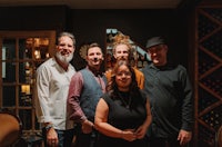 a group of people posing for a picture in a bar